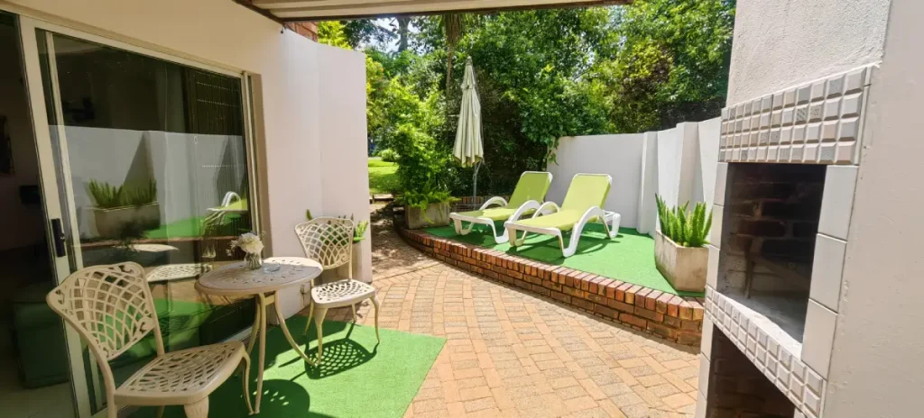 Outdoor Living Area with Barbecue at Andante Lodge in Pretoria